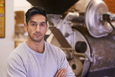 I take my coffee very seriously. a young man working with raw coffee beans.の写真素材