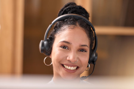 Woman, portrait and face smile in call center with headphones for customer service, support and telemarketing at the office. Happy female consultant, agent and smiling with headset for online adviceの写真素材