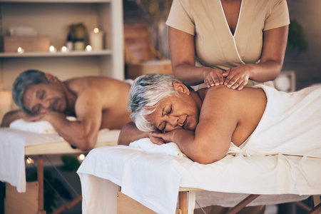 Massage, senior couple and spa with luxury, wellness and stress relief with vacation, relax and holistic health. Partners, mature woman and old man with grooming, treatment and zen with body careの写真素材