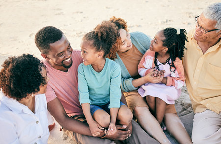 Big family, grandparents or children at beach to relax with girls or siblings on summer holiday together. Happy African dad, mom or young kids love bonding or relaxing with grandmother or grandfatherの写真素材