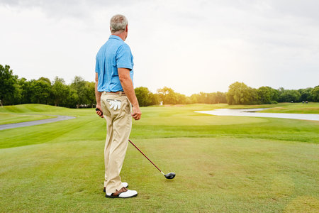 I like my courses uncrowded. a mature man out playing golf in his free time.の写真素材