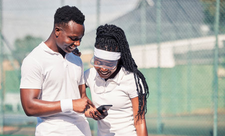 Tennis, couple and phone at happy training with laugh, smile and together for comic meme on social media. Man, black woman or tennis player with smartphone while rest at workout for fitness in summerの写真素材