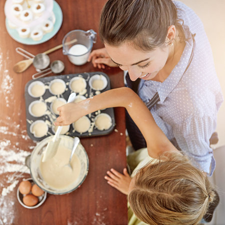 Youre my little baking star. a mother and her daughter baking in the kitchen.の写真素材