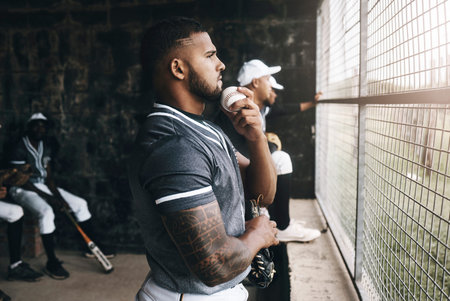 Baseball, man and watching game with a ball in a sports dugout with his team in club uniform. Latino...