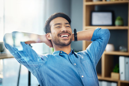 Business man, smile and stretching to relax from easy project, motivation and happiness in office. Cheerful worker, hands behind head and finish tasks, break and happy mindset goals for mental healthの写真素材