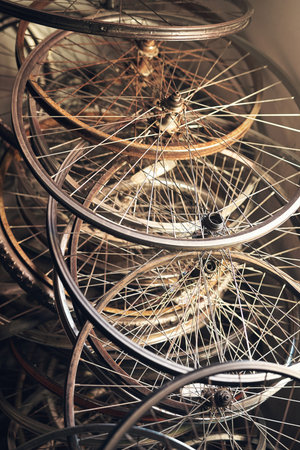 The wheels on the bus dont even go no more. bicycle wheel frames stacked on the floor.の写真素材