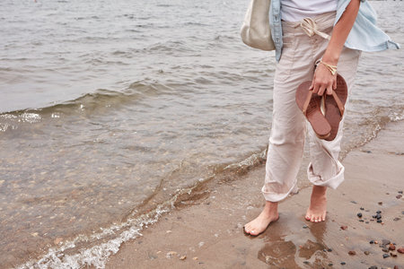 Disconnect and reconnect with nature. an unrecognizable woman going for a walk along the waters edge...
