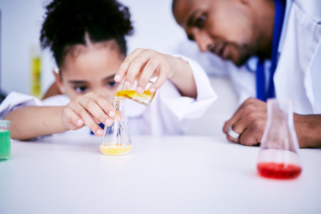 Science, experiment and child doing a project in a lab in physics or chemistry class in school. Knowledge, education and girl kid student working on a scientific analysis with glass beaker and liquidの写真素材