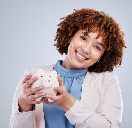 Piggy bank, portrait and happy woman isolated on studio white background for savings, investment or finance. African person or business worker budget, financial management and money safe or securityの写真素材