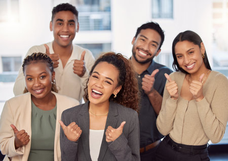 Portrait, support or thumbs up with a business team celebrating an achievement of a woman leader in the office. Wow, winner and motivation with a group of colleagues employees with a female managerの写真素材