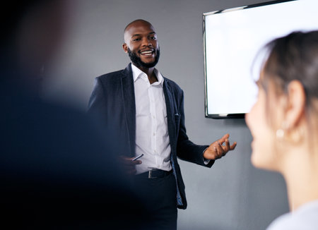 Meeting, presentation and training with a business black man in the boardroom for a coaching seminar. Management, education and planning with a young male speaker in he office during a workshopの写真素材