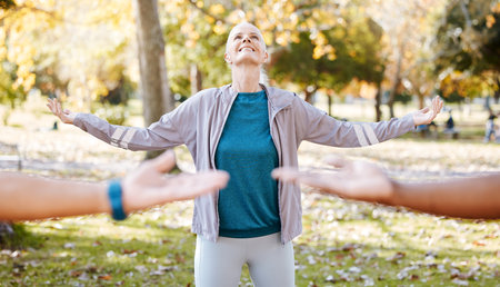 Stretching, yoga and teacher with old woman in park for fitness, health and workout. Mindfulness, training and wellness with senior people and meditation in nature for pilates, balance and classの写真素材
