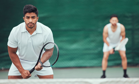Man, team and portrait on a tennis court for competition and wellness for health in india. Male athlete, racket and together for a game in the outdoor at a sports club for training with challenge.の写真素材