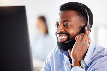Black man, face and headset, callcenter and contact us with customer service agent in workplace with smile. CRM, phone call and tech support with telecom, male consultant for help desk at computerの写真素材