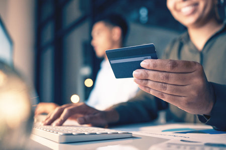 Hands, computer and credit card for ecommerce, online shopping or banking at night on office desk....
