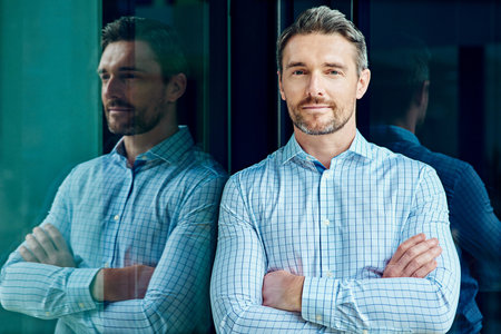 Staying focused in the pursuit of success. Portrait of a successful businessman at work.の写真素材