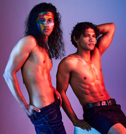 Creative, body and men models in neon background for creativity with paint as artwork isolated on a purple studio backdrop. Colorful, muscle and artistic people for skin, beauty or fashion poseの写真素材