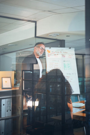To know your audience, listen to them. a mature businessman delivering a presentation in the boardroom of a modern office.の写真素材