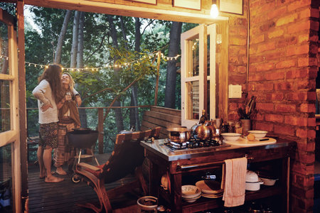 We could get used to this life. a young couple preparing dinner while on vacation in a cabin.