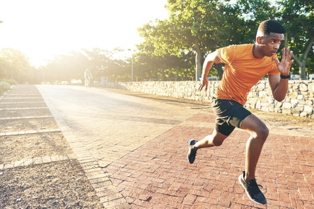 Running is the best way to experience the world. a young man out for a run.の写真素材
