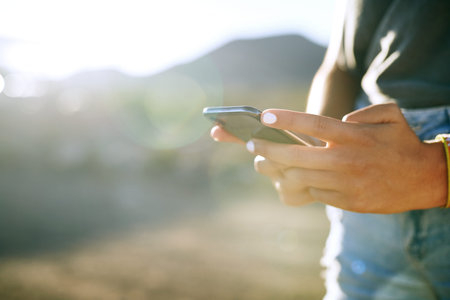 Even nature has a wifi hotspot. an unrecognisable woman using a smartphone on a farm.