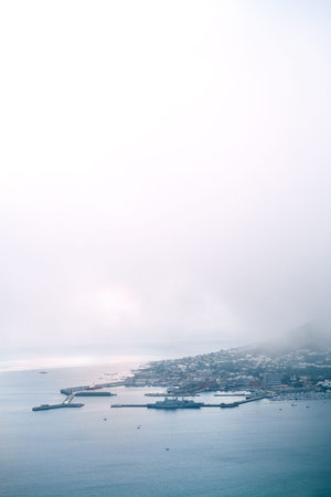 A typical day in the city. a busy coastal village on a mountain side during the day.