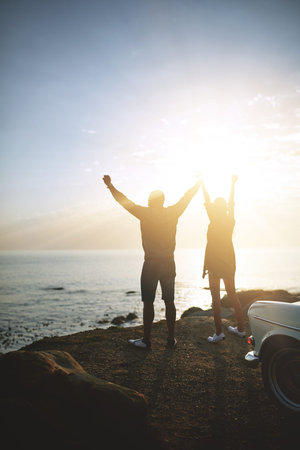 Live in the moment. a young couple making a stop at the beach while out on a road trip.