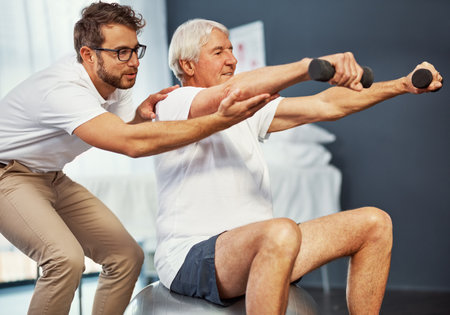 Hold it just there. a senior man working on his recovery with a male physiotherapist.の写真素材
