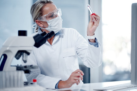 Youve got to work with extreme caution. a mature scientist working in her lab.の写真素材
