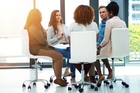 Theres nothing that cant be achieved with teamwork. a team of colleagues having a meeting in a modern office.の写真素材
