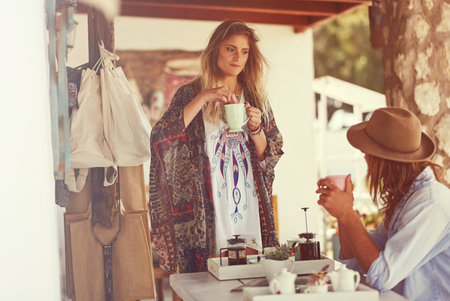 Are you ready to hit the road yet. a free spirited young couple enjoying coffee together at a roadside shop.の写真素材