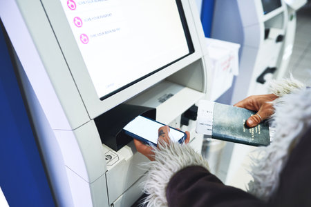 Almost time to get going. a woman checking in for her flight at the airport.の写真素材