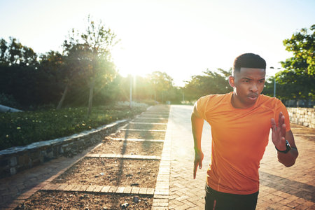 I put in the work to reach my goals. a young man out for a run.の写真素材