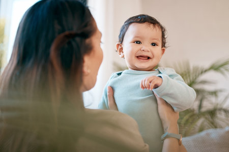 Family, love and mother play with baby for bonding, quality time and child development together at home. New born, motherhood and happy mom carry infant for care, support and affection in living roomの写真素材