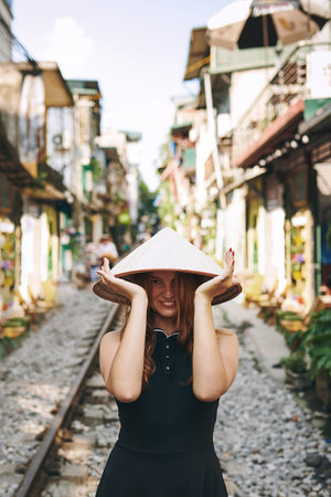 Traveling should excite and inspire you. a young woman wearing a conical hat while exploring a foreign city.の写真素材