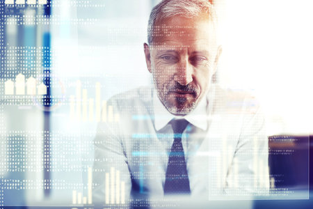 Working on his code. a mature businessman working on programming code.の写真素材