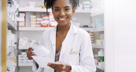 Trust me to do your dispensing accurately. Cropped portrait of an attractive young pharmacist filling a prescription in a chemist.の写真素材