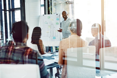 Earn your leadership every day. A businessman giving a presentation to coworkers in the boardroom.