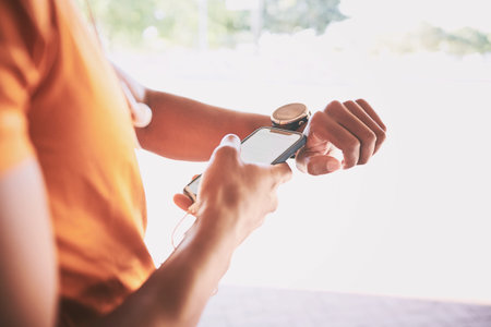 The tech that takes your workout to the next level. a man pairing his watch with a smartphone during...