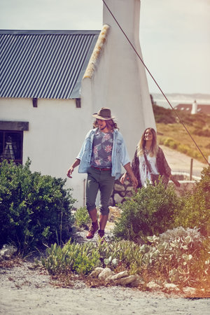 Theyre happiest when theyre outside. an adventurous young couple exploring a small town together on a weekend getaway.の写真素材