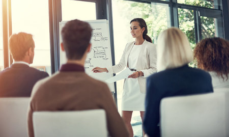 Shes created a powerful action plan for them to follow. a businesswoman giving a presentation to her...