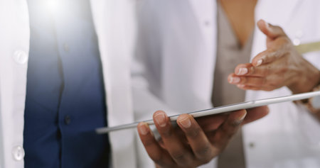 Reaching those medical breakthroughs wirelessly. Closeup shot of two unrecognizable healthcare...