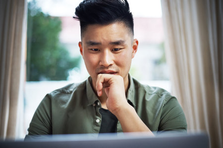 Working with an idea in mind. a handsome young man working on his laptop at home.