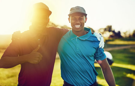 We had so much fun playing golf together. two friends standing together on a golf course.