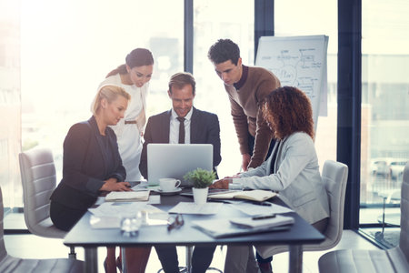 Leave it to the professionals. a group of corporate businesspeople meeting in the boardroom.の写真素材