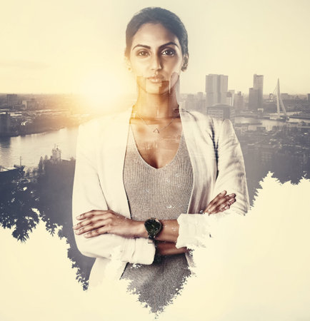 Queen of the concrete jungle. Portrait of an attractive young businesswoman superimposed over a cityscape.の写真素材