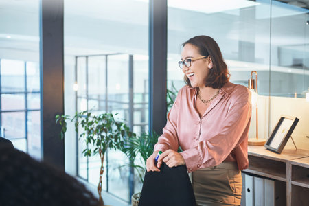 Nothing more infectious than positivity. a young businesswoman delivering a presentation to her coworkers in the boardroom of a modern office.の写真素材