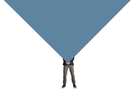 At what point does it become too much. a businessman carrying a heavy load against a white background.の写真素材