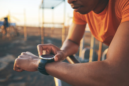 I have the time of my life when Im out exercising. a man checking his watch while out for a workout.の写真素材