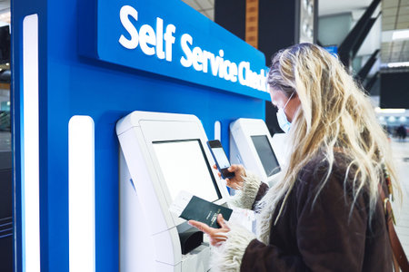 This looks harder then it seems. a young woman checking in for her flight at the airport.の写真素材